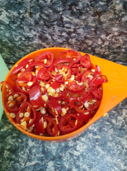 Picture of chopped birds eye chillies with seeds left in.