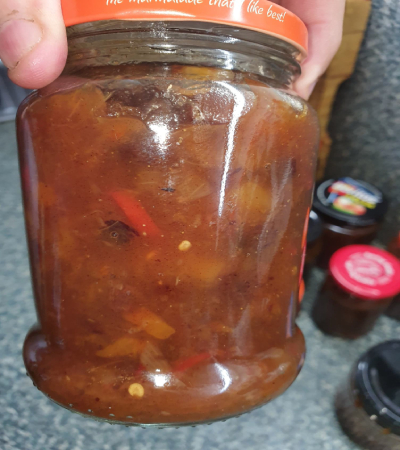 Finished chutney placed into a jar for storage.