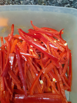Picture of red chillies cut length-wise and seeds removed.